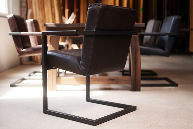 Ergonomischer Leder-Schwingstuhl mit Armlehnen und robustem Stahlrahmen ideal für lange Abendessen oder Arbeitsstunden